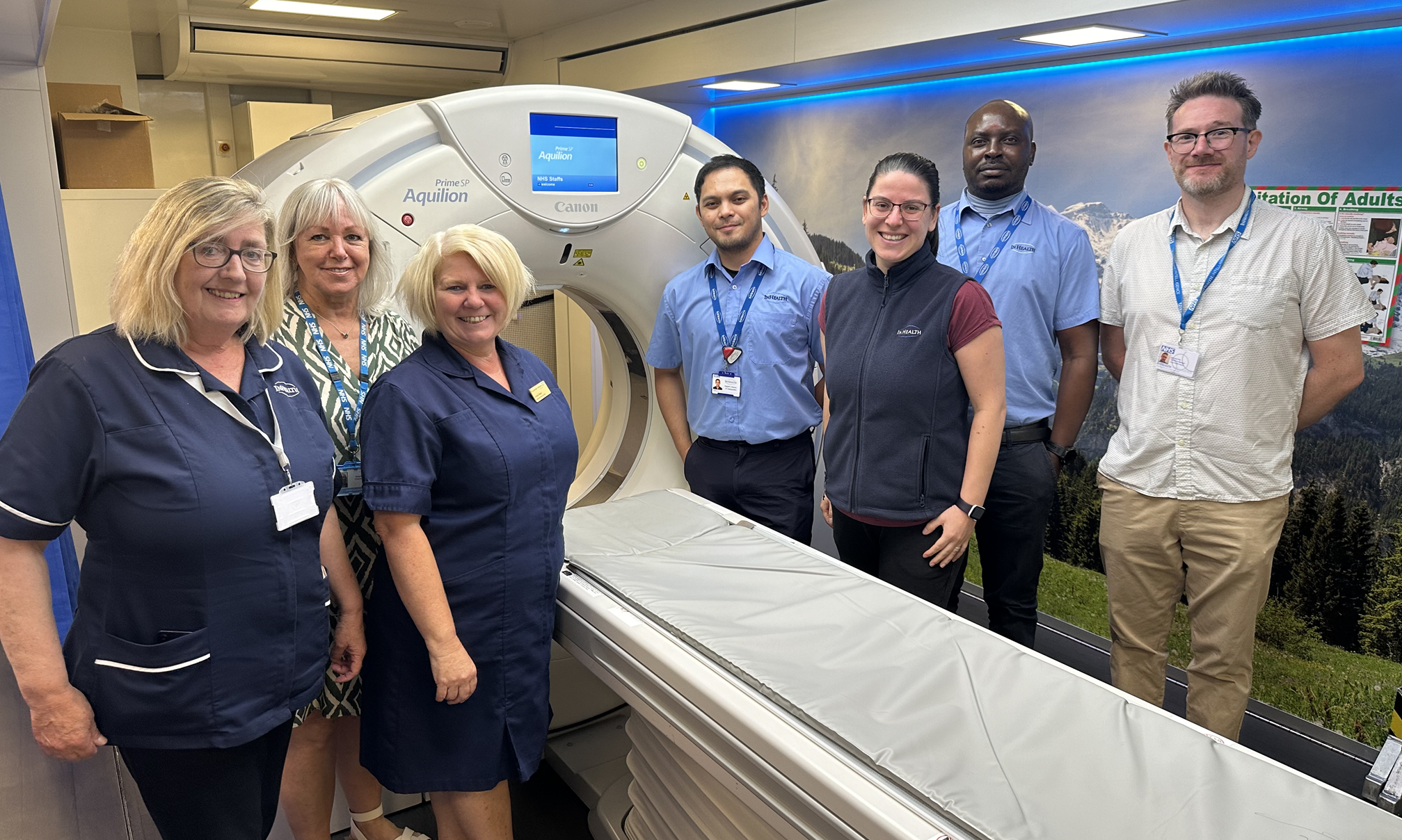 A group of NHS professionals standing by a CT scanner